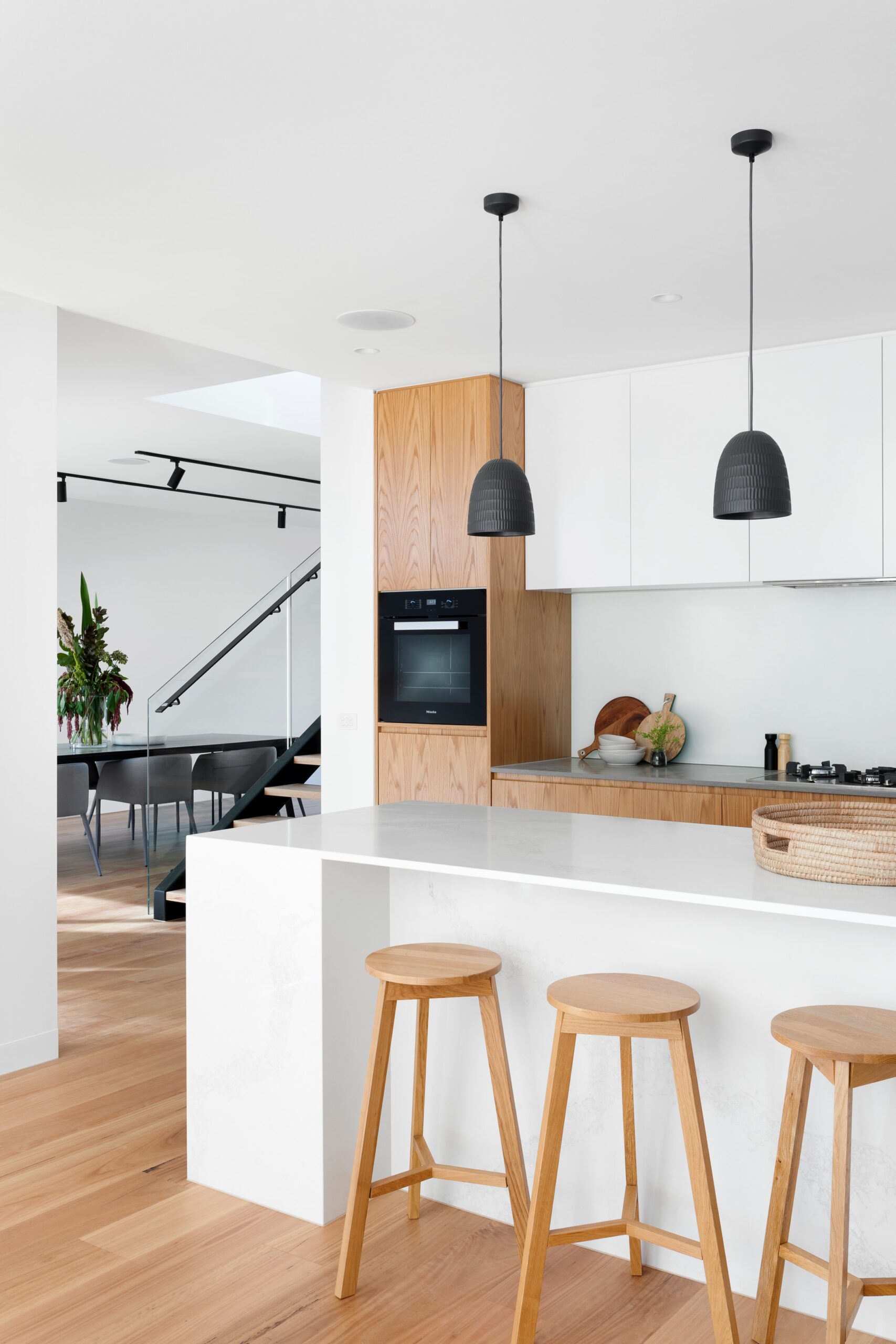 Modern kitchen remodeling inspiration with white cabinets, wood accents and a large island