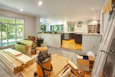 Shelves, circular saw, doors and other remodeling tools and supplies fill the family room as the kitchen is worked on